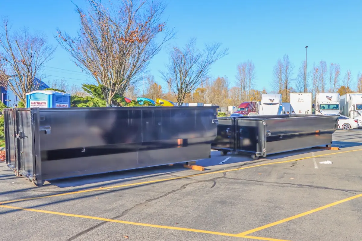 Professional dumpster rental service with roll-off container on residential driveway in Beltsville